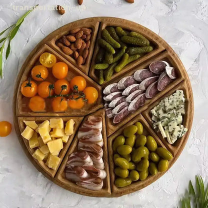 Wooden charcuterie board with various foods including cheese, meats, and vegetables on a light background.