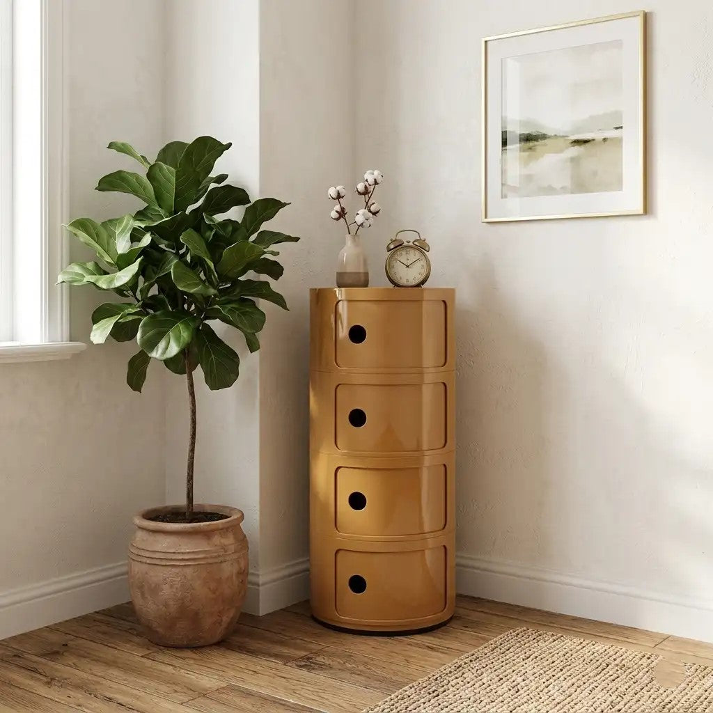 Wooden chest of drawers next to a potted plant in a room with a clock and decor.