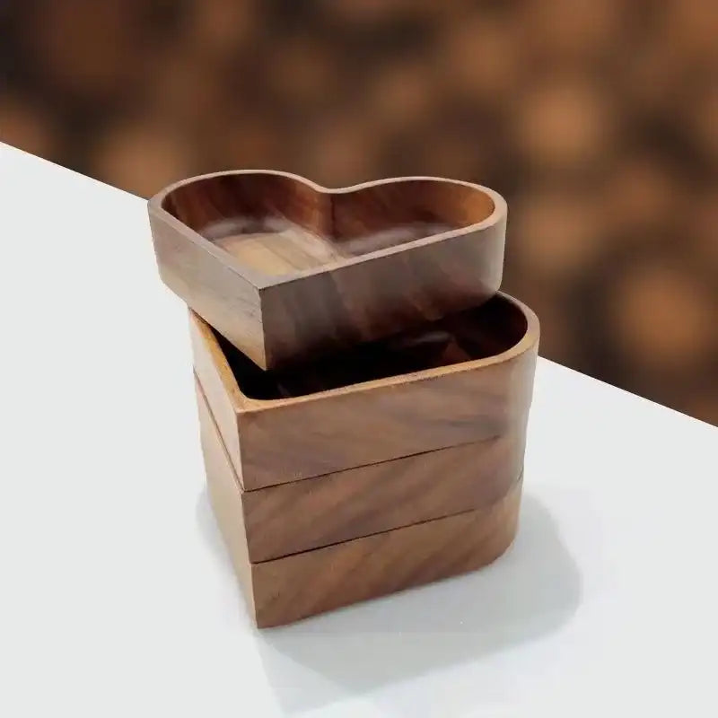 Wooden heart-shaped container on a white surface with a blurred brown background
