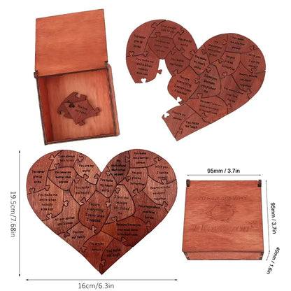 Wooden heart-shaped puzzle with engraved text, accompanied by a wooden box, on a white background.