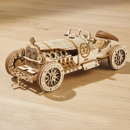 Wooden model of a vintage car on a wooden surface