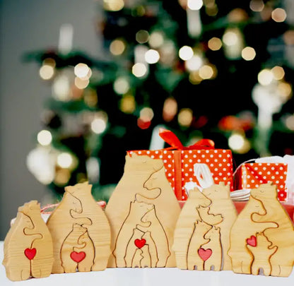 Wooden cat-shaped ornaments with red hearts in front of a Christmas tree.