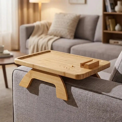 Wooden tray attached to a gray sofa in a living room setting