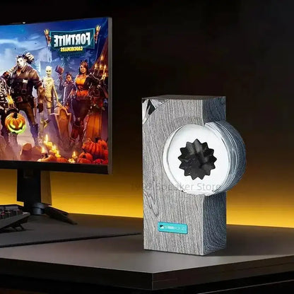 Gaming setup with a monitor displaying a game and a music visualizer on a desk.