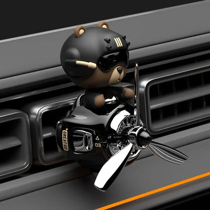  bear with a helmet and goggles on a car grille
