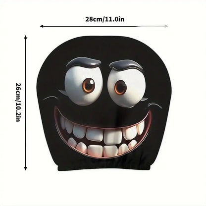 Black cushion with a cartoon face design and measurements on a white background