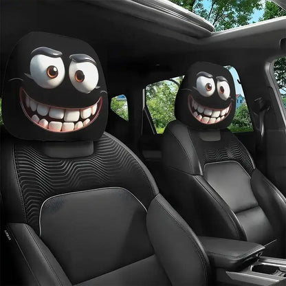 Car headrest covers with cartoonish faces in a vehicle interior.
