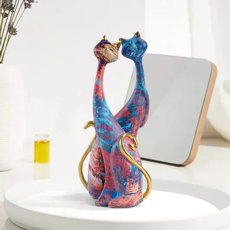 Colorful cat-shaped decorative sculpture on a white surface with a neutral background