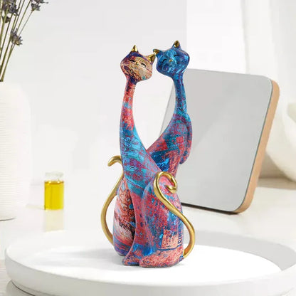 Colorful cat-shaped decorative sculpture on a white surface with a neutral background