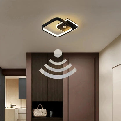 Modern ceiling light fixture in a room with a door and interior decor.