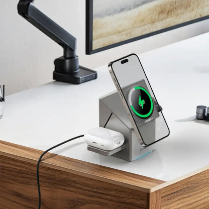 Desk setup with a smartphone on a charging stand displaying a charging icon, next to a pair of wireless earbuds.