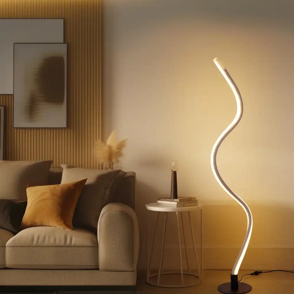 Modern living room with a curved floor lamp, sofa, and side table.