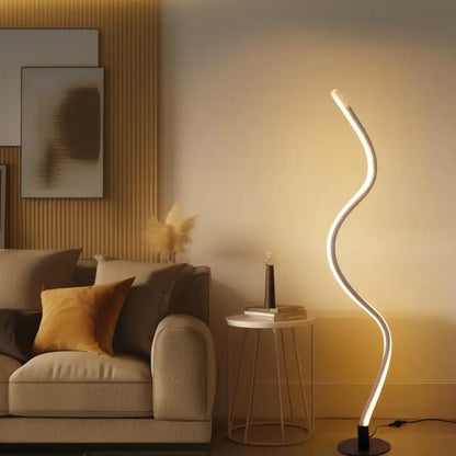 Modern living room with a curved floor lamp, sofa, and side table.