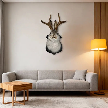 Living room with a gray sofa, wooden coffee table, and deer head mount on the wall.