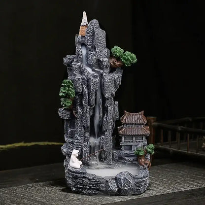Decorative mountain with incense burner and pagoda on a dark background