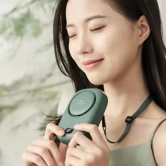 Woman holding a green electronic Bladeless Neck Fan with a blurred natural background