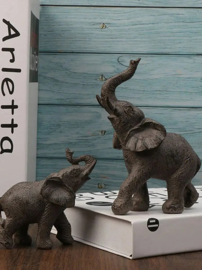 Two elephant figurines on a box with a wooden background