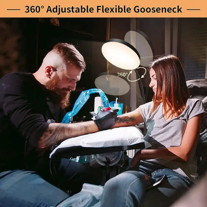 Tattoo artist working on a client with a 360-degree adjustable flexible gooseneck light.