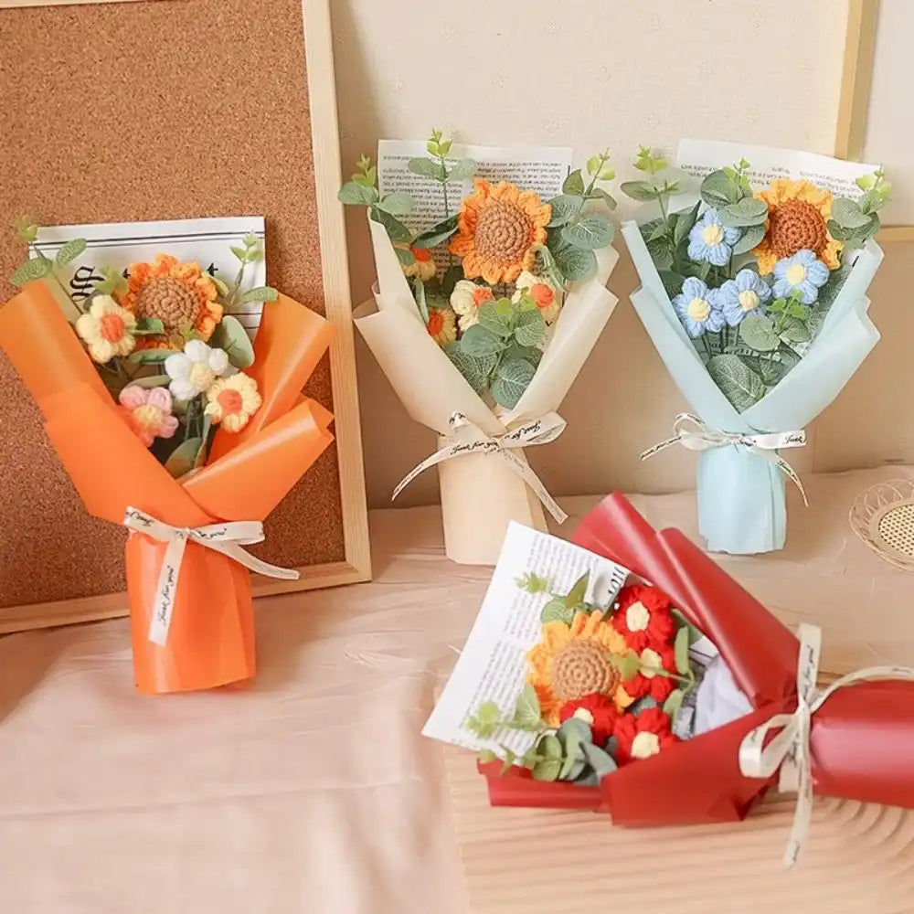 Five small flower bouquets in different colors on a wooden surface.