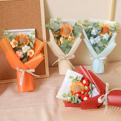 Five small flower bouquets in different colors on a wooden surface.