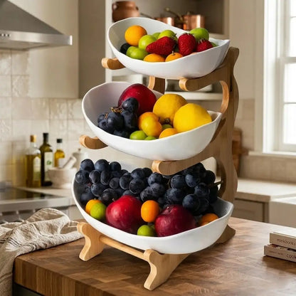 Three-tiered fruit basket with various fruits on a kitchen counter