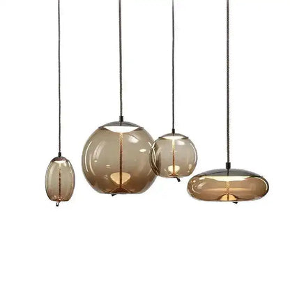 Set of four hanging pendant lights with glass shades on a white background