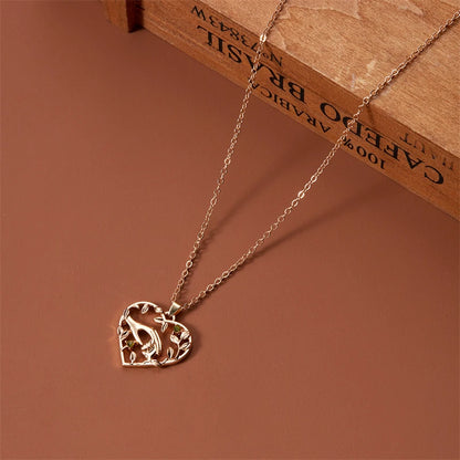 Gold heart-shaped pendant necklace on a brown background