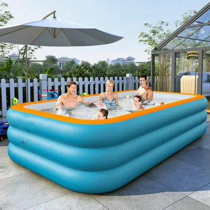 Family enjoying a hot tub in an inflatable pool outdoors with a white umbrella and greenery in the background.