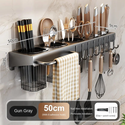 Wall-mounted kitchen organizer with utensils and tools on a neutral background