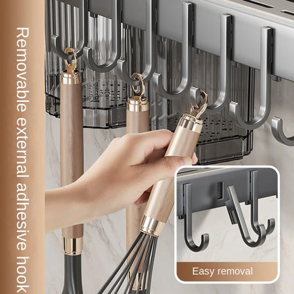 Wall-mounted hook system with a hand holding a whisk, emphasizing easy removal feature.