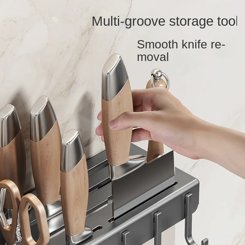 Multi-groove storage tool with smooth knife removal feature, hand interacting with it.