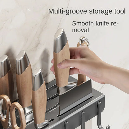 Multi-groove storage tool with smooth knife removal feature, hand interacting with it.