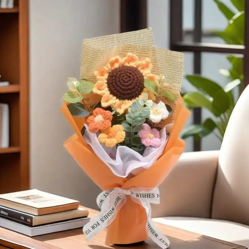 Bouquet of knitted flowers with a card on a table