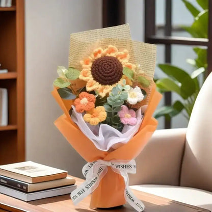 Bouquet of knitted flowers with a card on a table