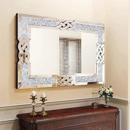 Decorative mirror with intricate frame above a wooden console table.