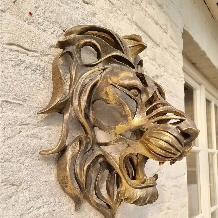 Bronze lion head sculpture on a stone wall