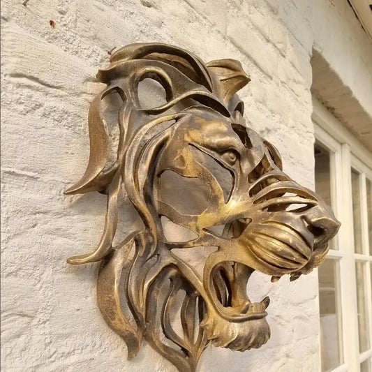 Bronze lion head sculpture on a stone wall