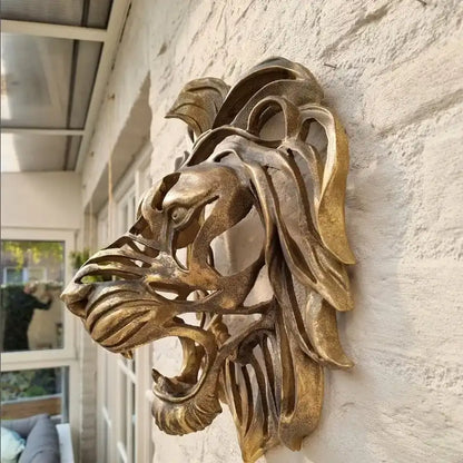 Bronze lion head sculpture on a stone wall