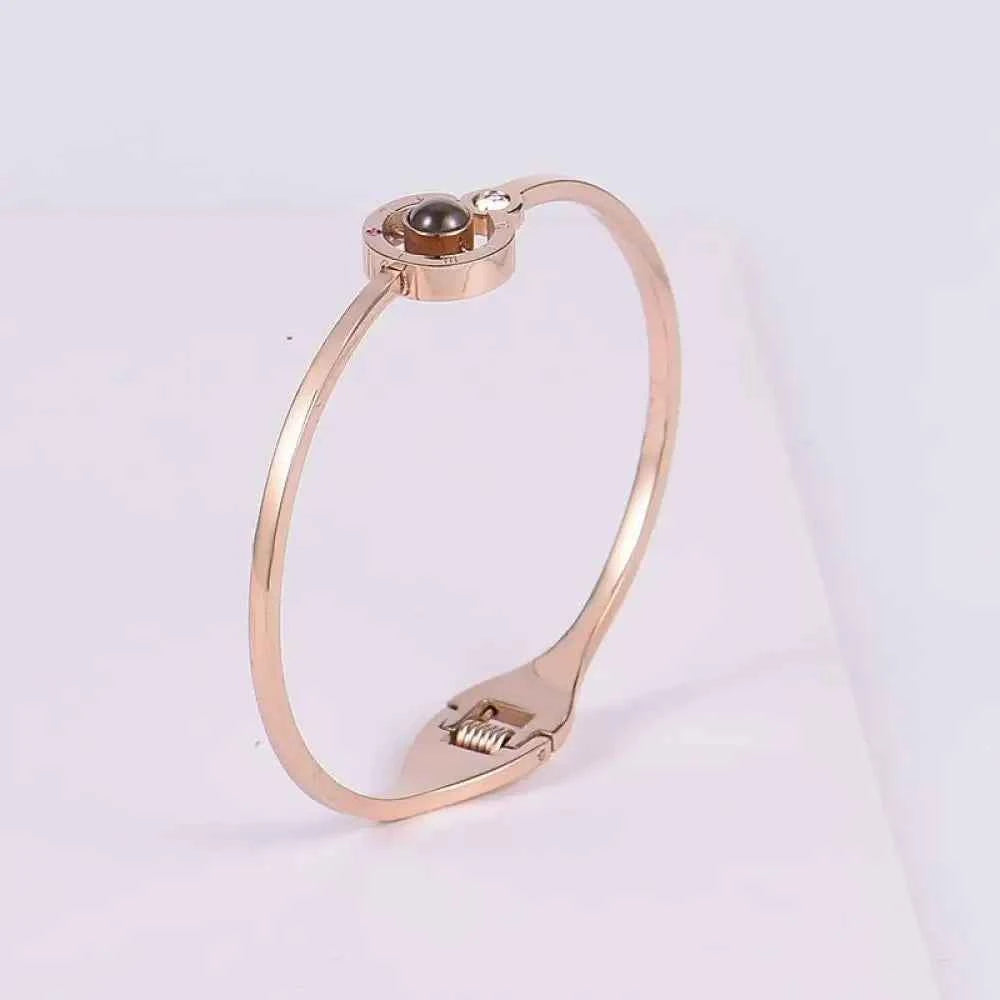 Rose gold bangle-style lover bracelet with black pearl and diamond accents