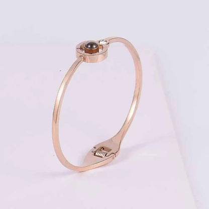 Rose gold bangle-style lover bracelet with black pearl and diamond accents