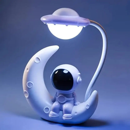 Decorative lamp with a moon-shaped base and UFO top on a blue background