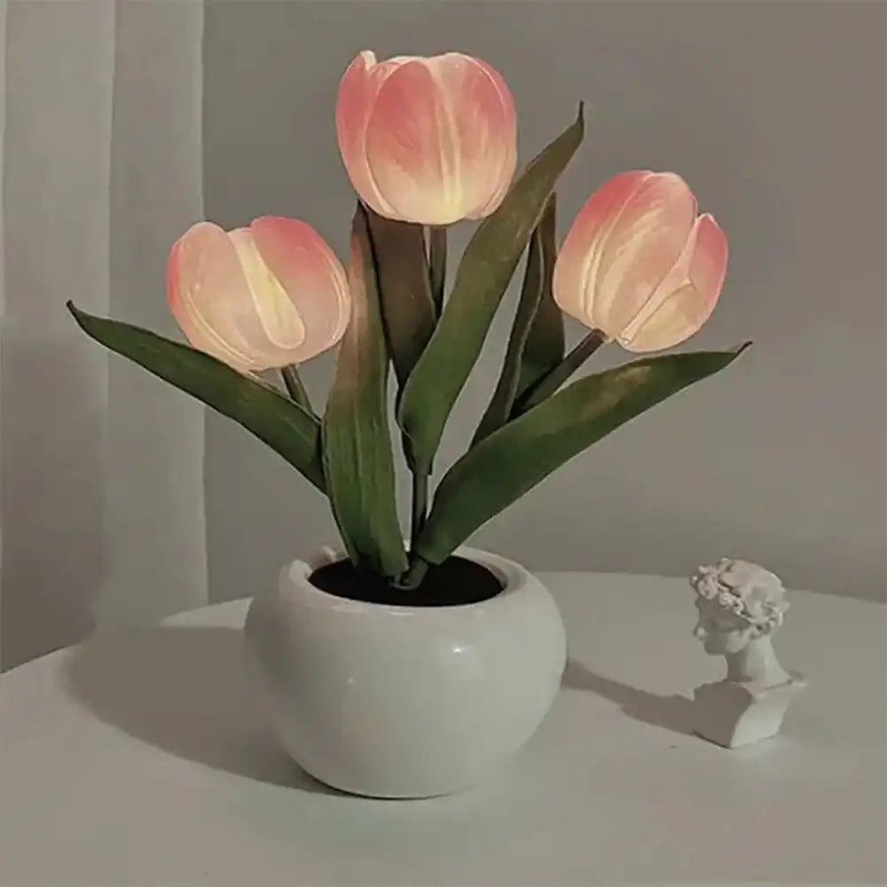 Potted plant with pink tulips on a neutral background