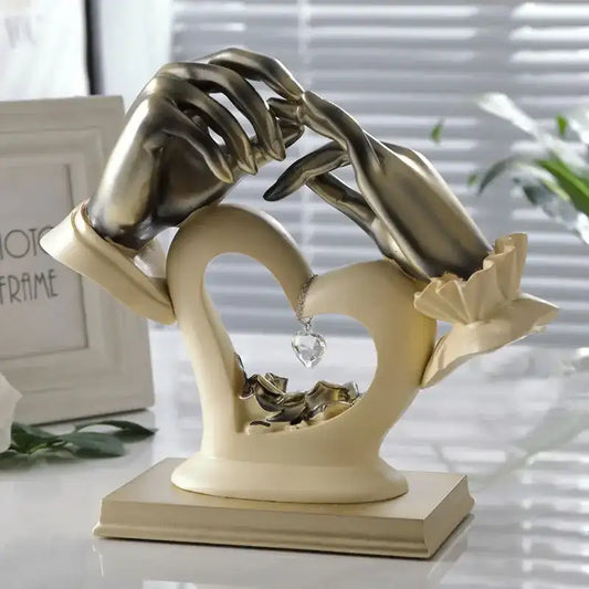 Decorative sculpture of hands holding a heart with swans, on a neutral background.