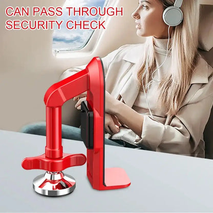 Red security check device with a person sitting in an airplane seat wearing headphones.
