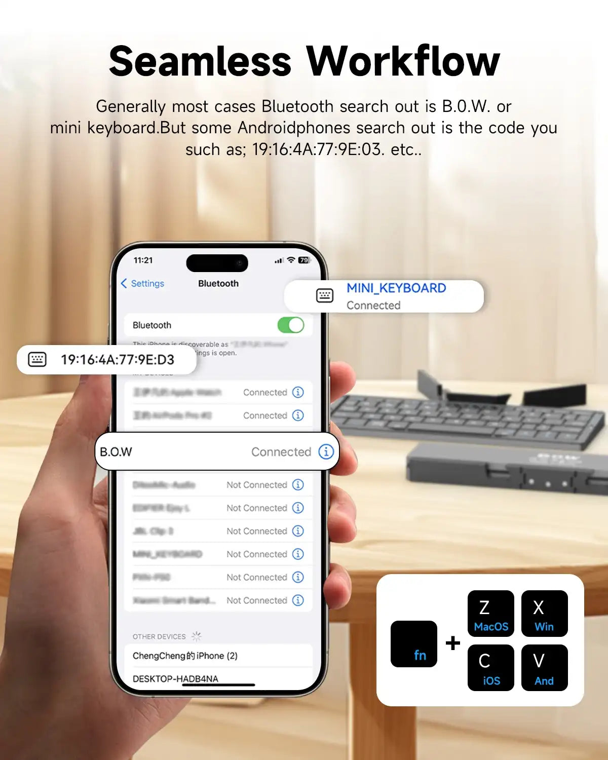 Hand holding a smartphone displaying Bluetooth connectivity with a keyboard in the background.