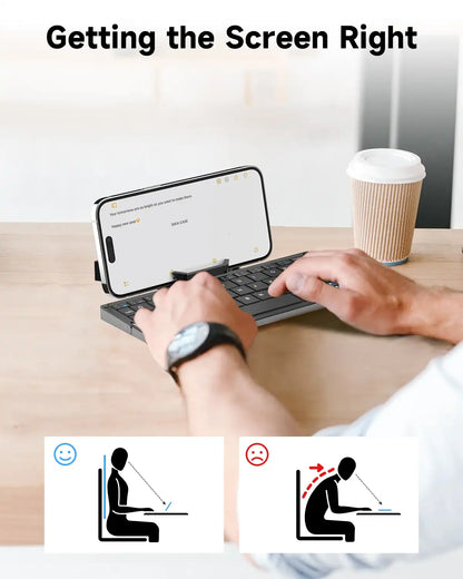 A person using a smartphone with a keyboard stands on a desk, with ergonomic icons displayed.