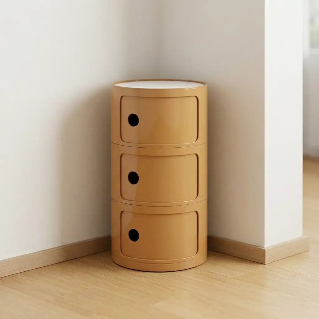 Wooden storage unit with three drawers against a white wall.