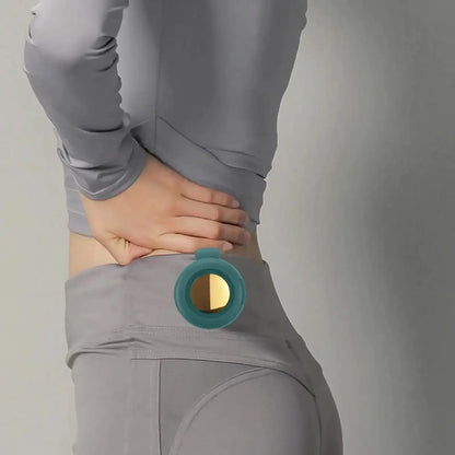Person wearing gray athletic wear with a teal and gold Clip-On Portable Fan on a plain background