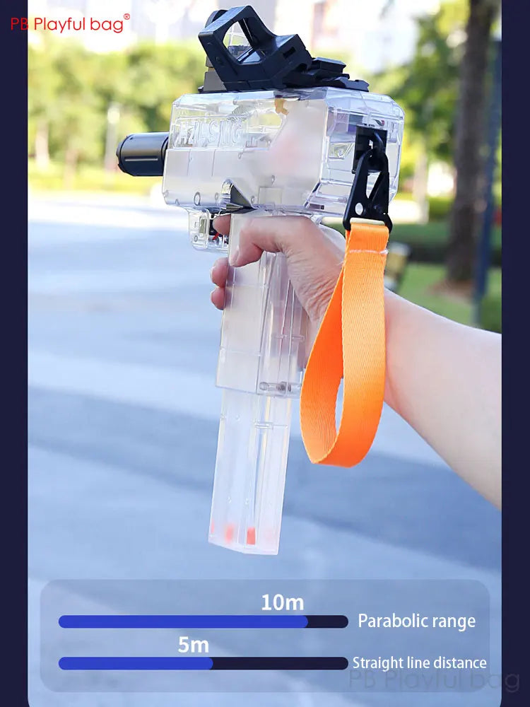 Hand holding a transparent water gun with an orange handle, outdoors.