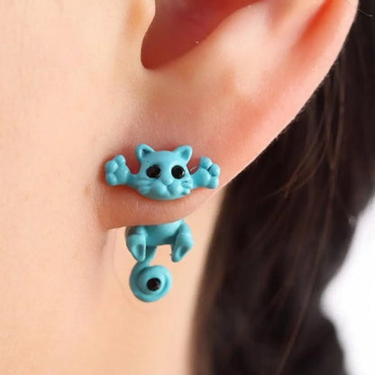 Turquoise cat-shaped earring worn on an ear